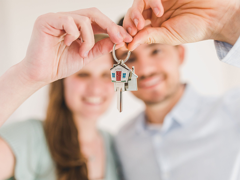photo of people holding keys to new house